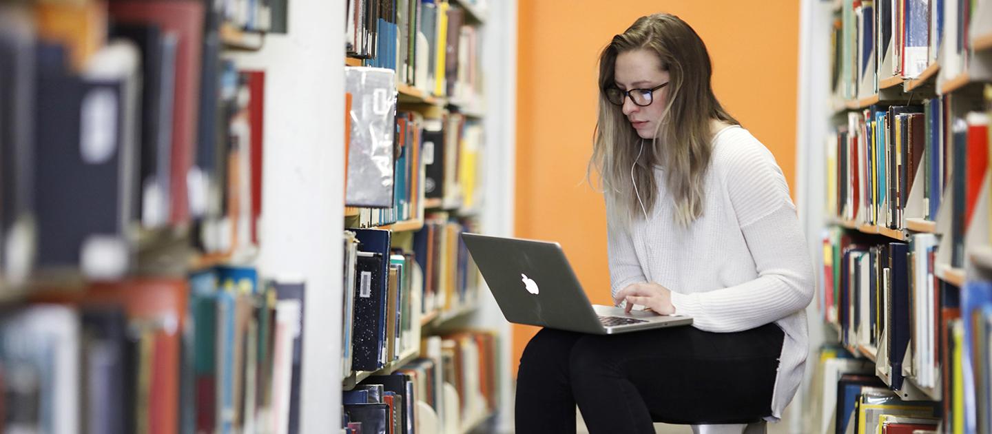 Student studying in library.