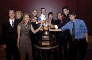 Aviation and Aerospace members standing with trophy