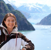 Photo of Keah Schuenemann posing in front of an Alaskan Glacier