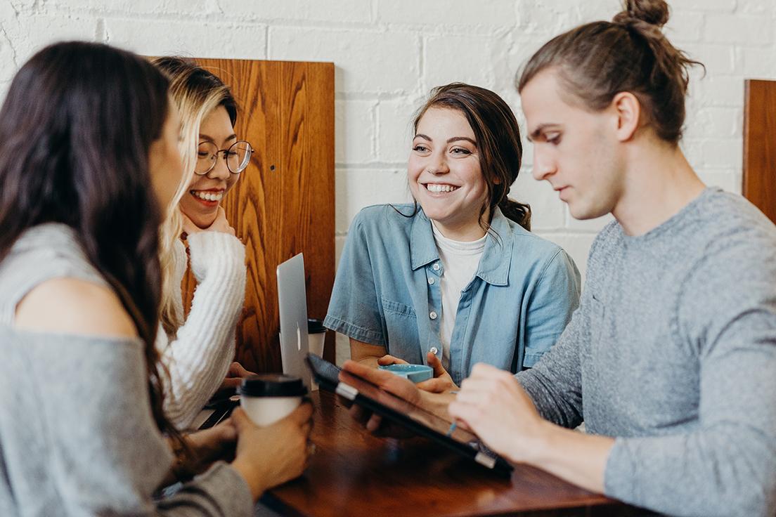 Group of students studying at a cafe