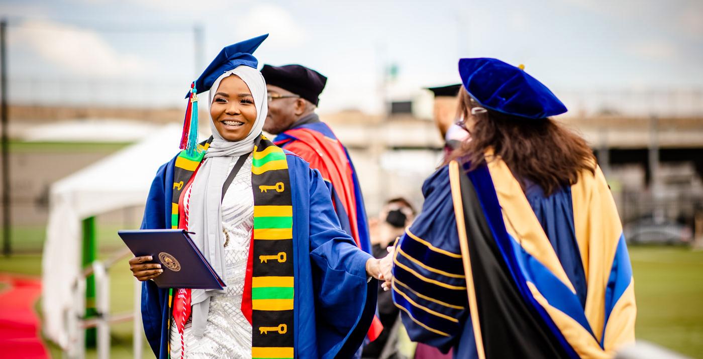 Student receiving diploma at graduation