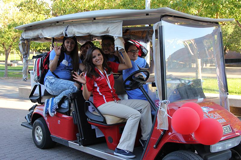 Students and team members in an MSU Denver golf cart