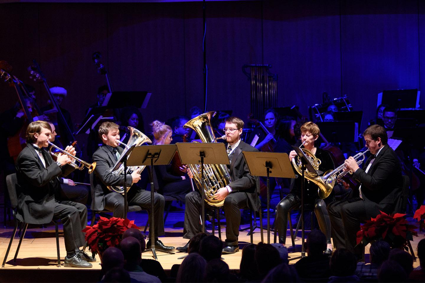 Horn Quintet performing under blue lights in the King Center Concert Hall