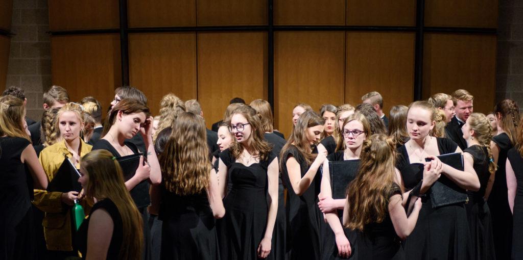 Choir participants backstage before concert