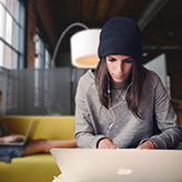 Person sitting and working on laptop