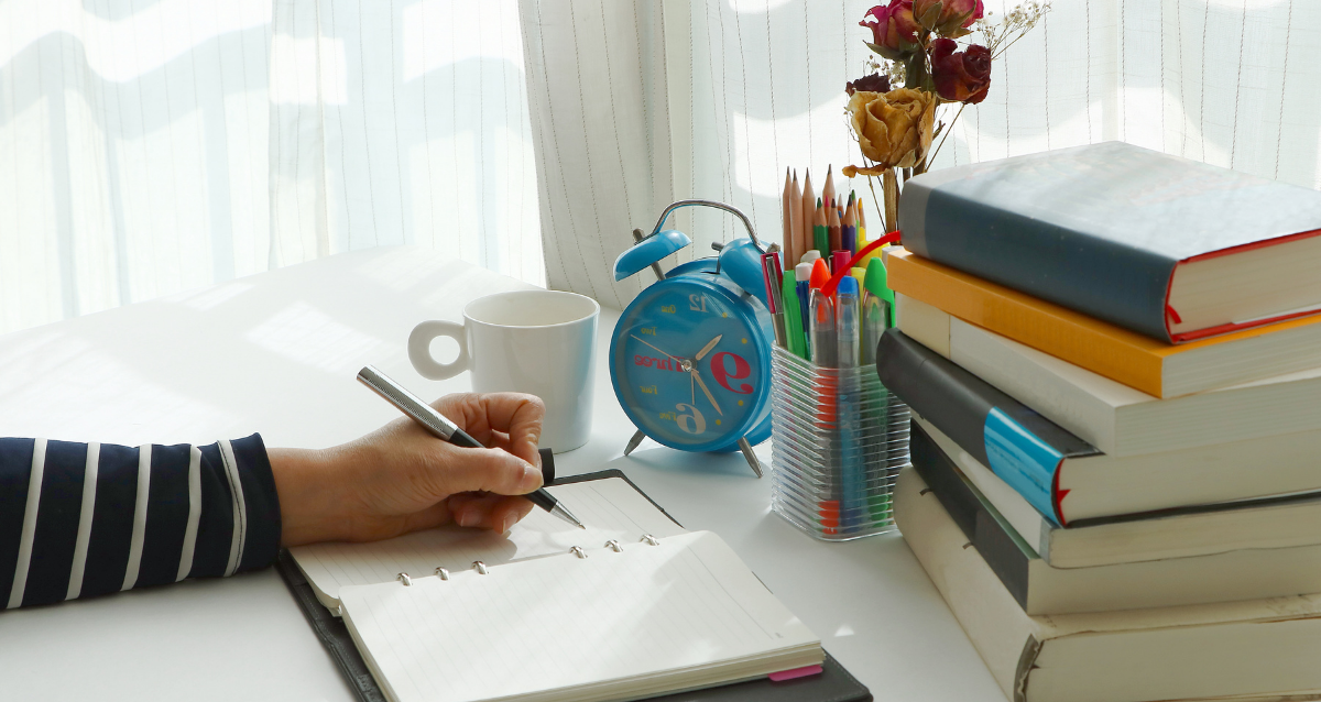 A person writing in a notebook