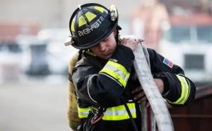 MSU Denver student and Denver Fire Academy firefighter Jacob Stephens running through drills in firefighter uniform.