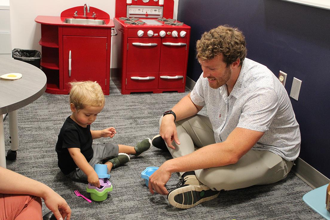 Graduate MS SLP student (left) working with toddler aged child (right)