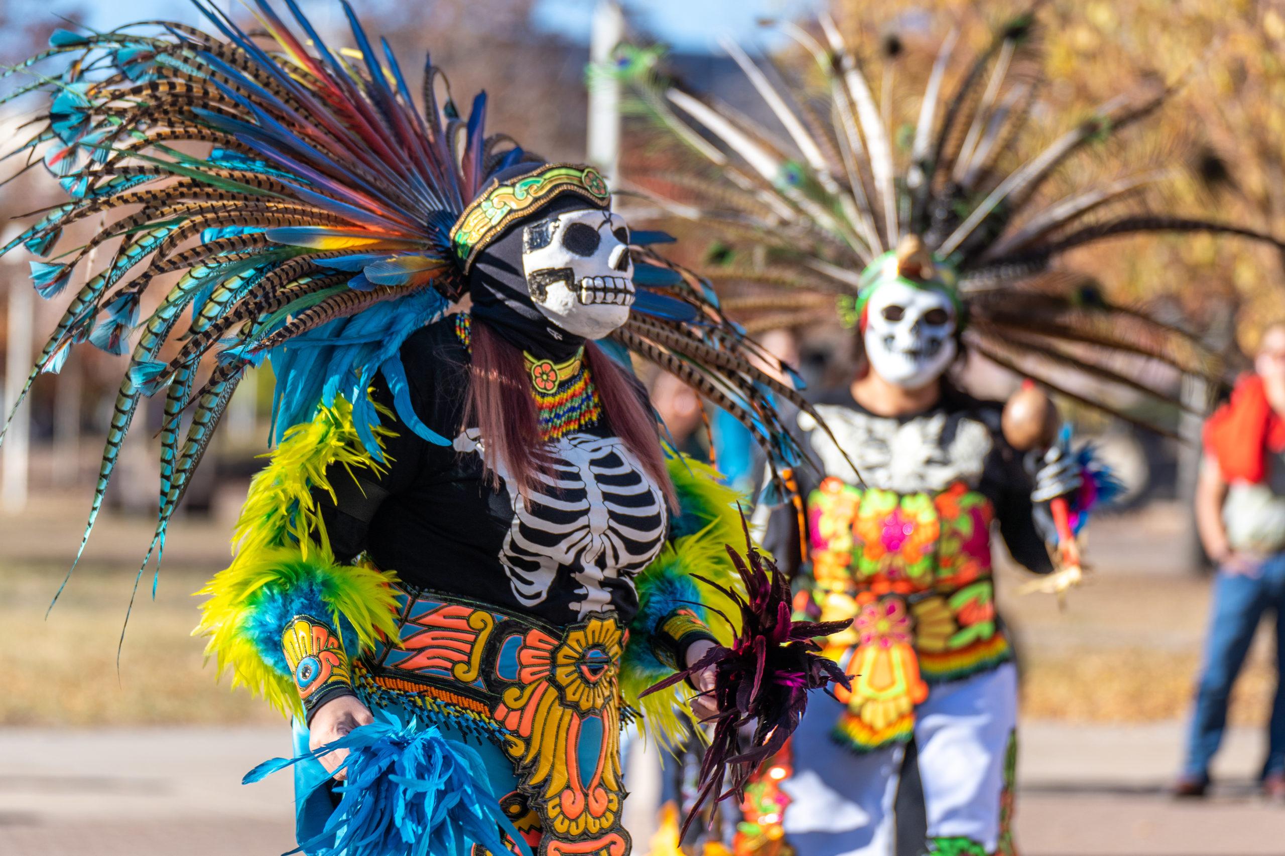 People in Dia De Los Muertos Regalia