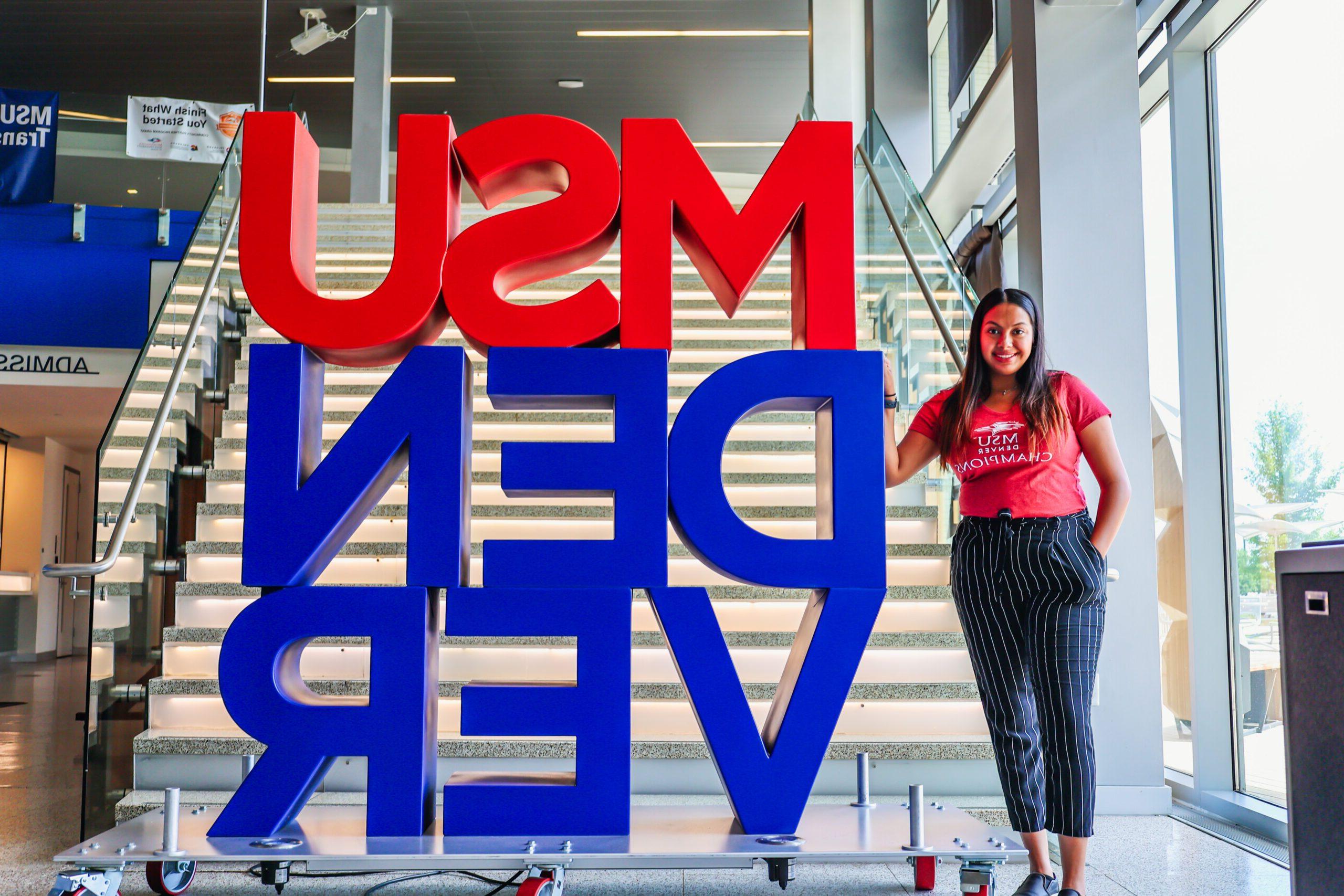 Student in front of MSU Denver sign