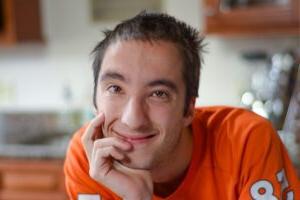 Portrait photograph of a student smiling and wearing a Denver Broncos jersey.