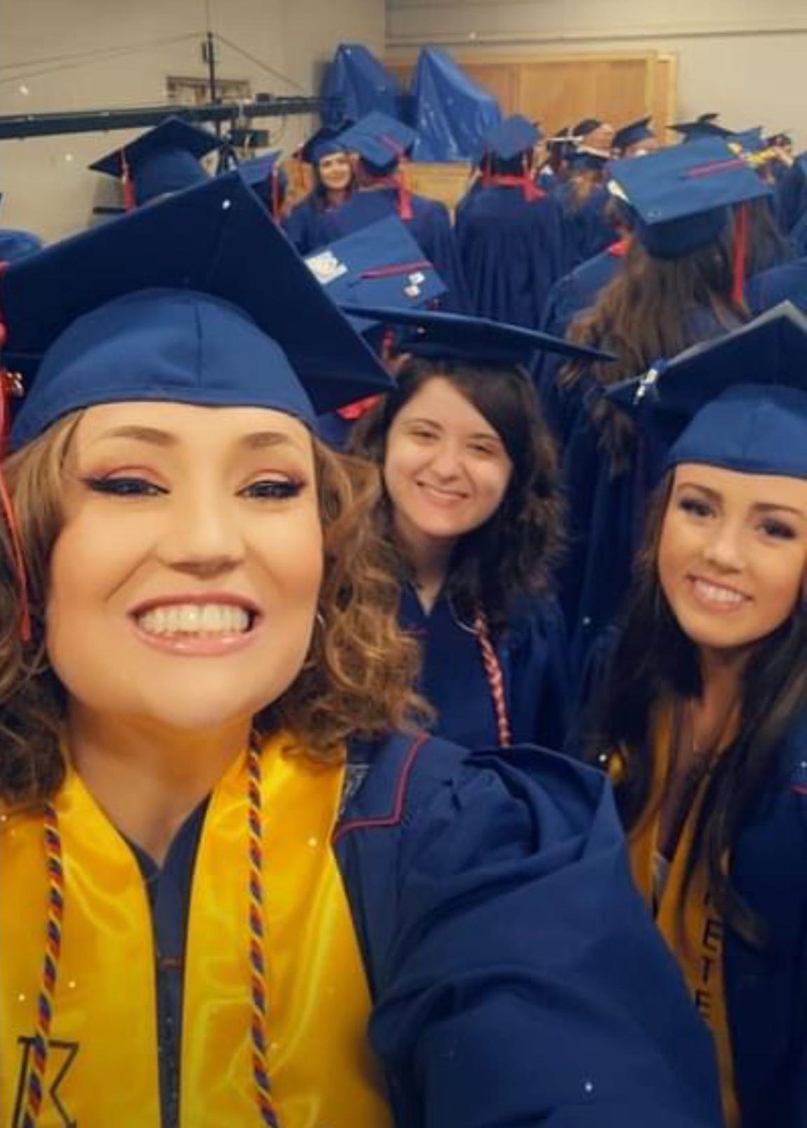 Graduates pose at their ceremony