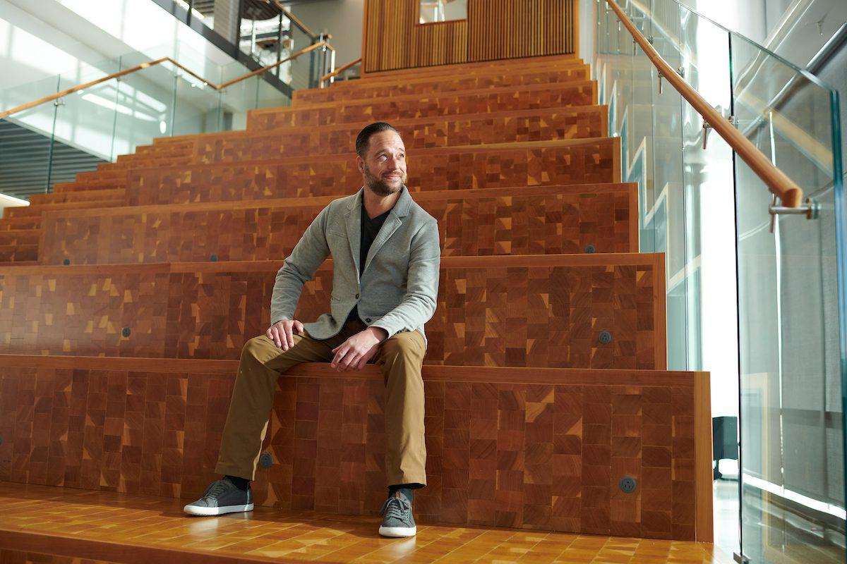 Student sitting on stairs in the AES building.