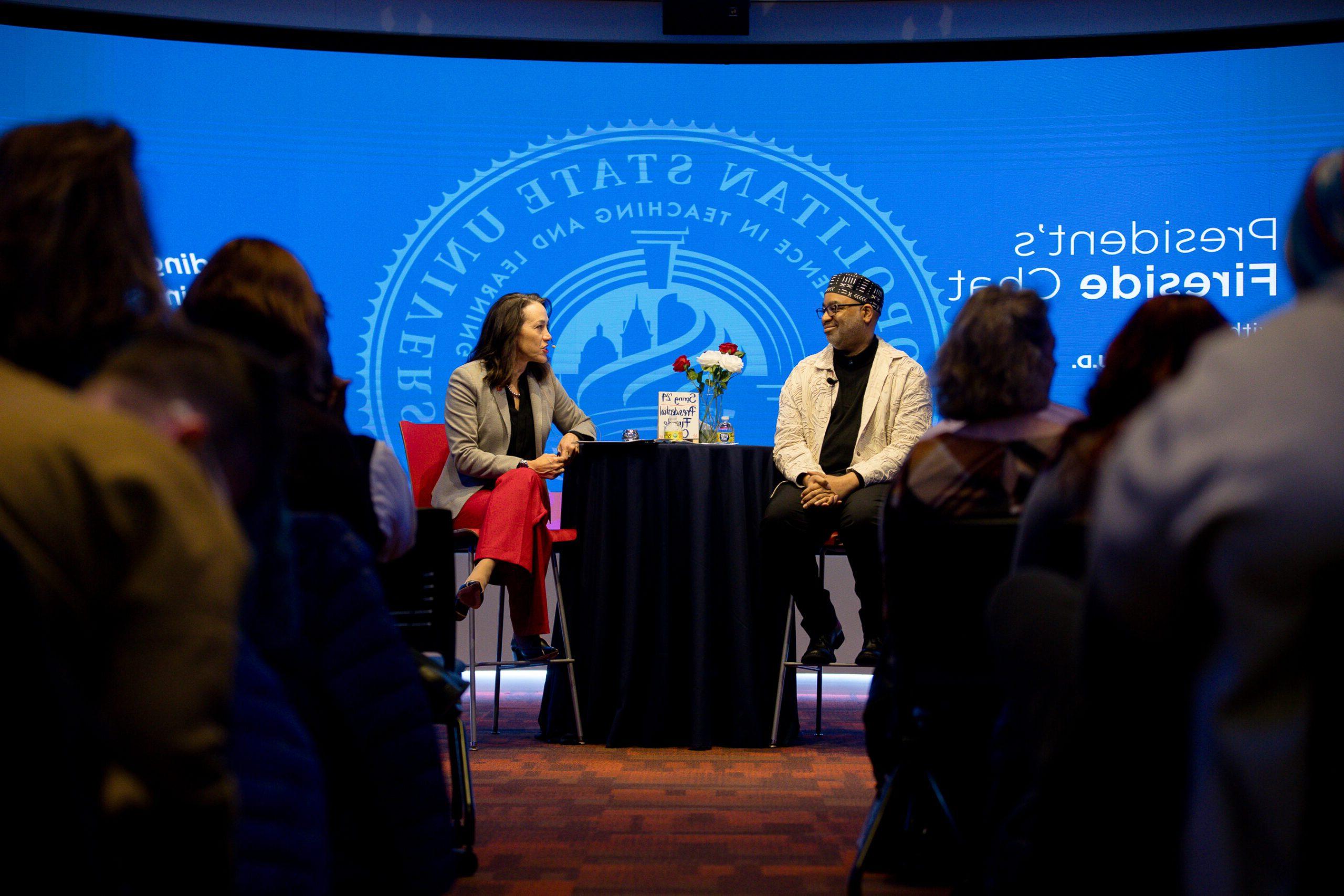 President Davidson and Adrain Miller talking at the Fireside Chat