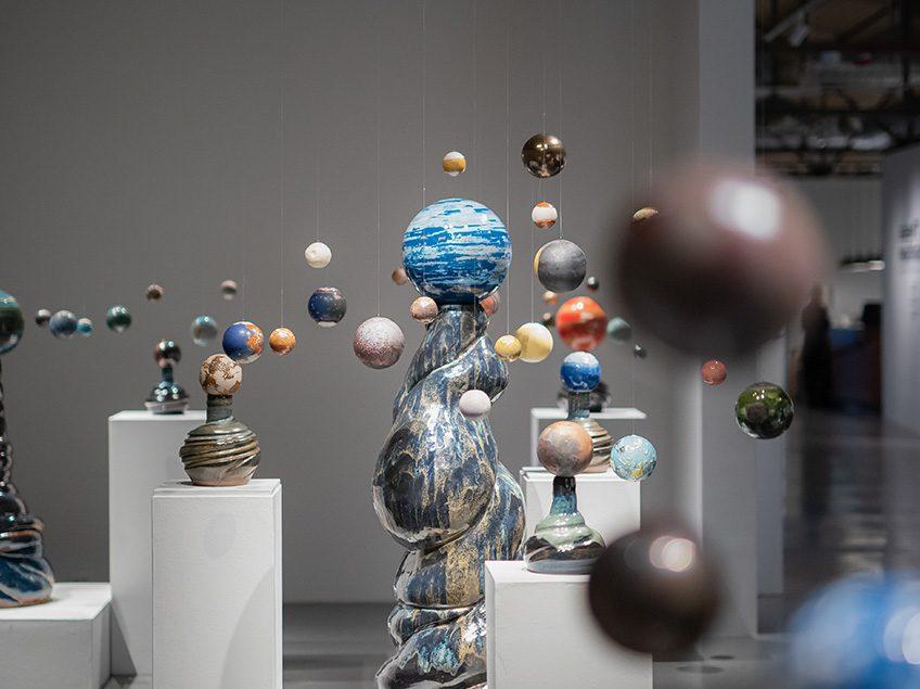 Sculptures reminiscent of the solar system, each ball is decorated with different glazes and surround the tallest globe.