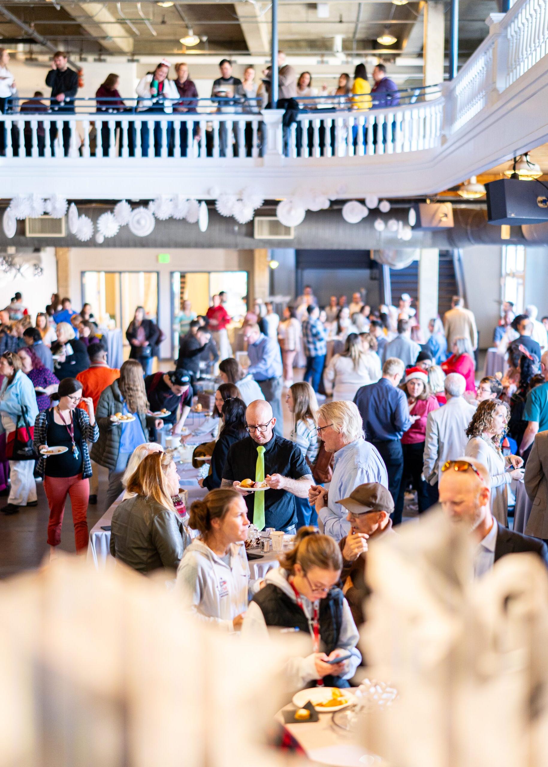 A large crowd of guests mingling at the annual Staff and 教师 Holidayfest