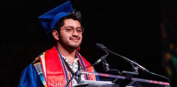 President's Award Winner, Gaberiel Trujillo, stands at the podium, addressing his classmates at Commencement