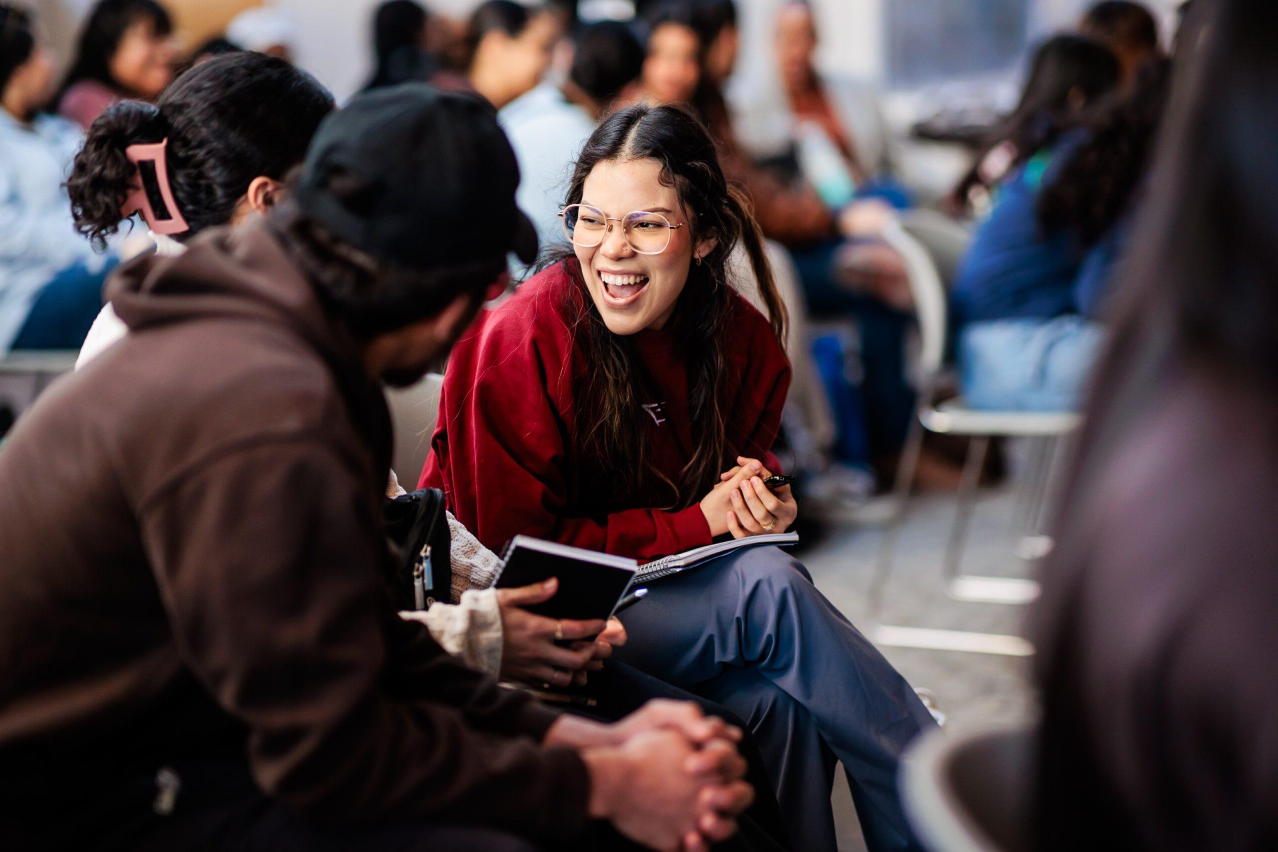 Girl looking at another person while laughing