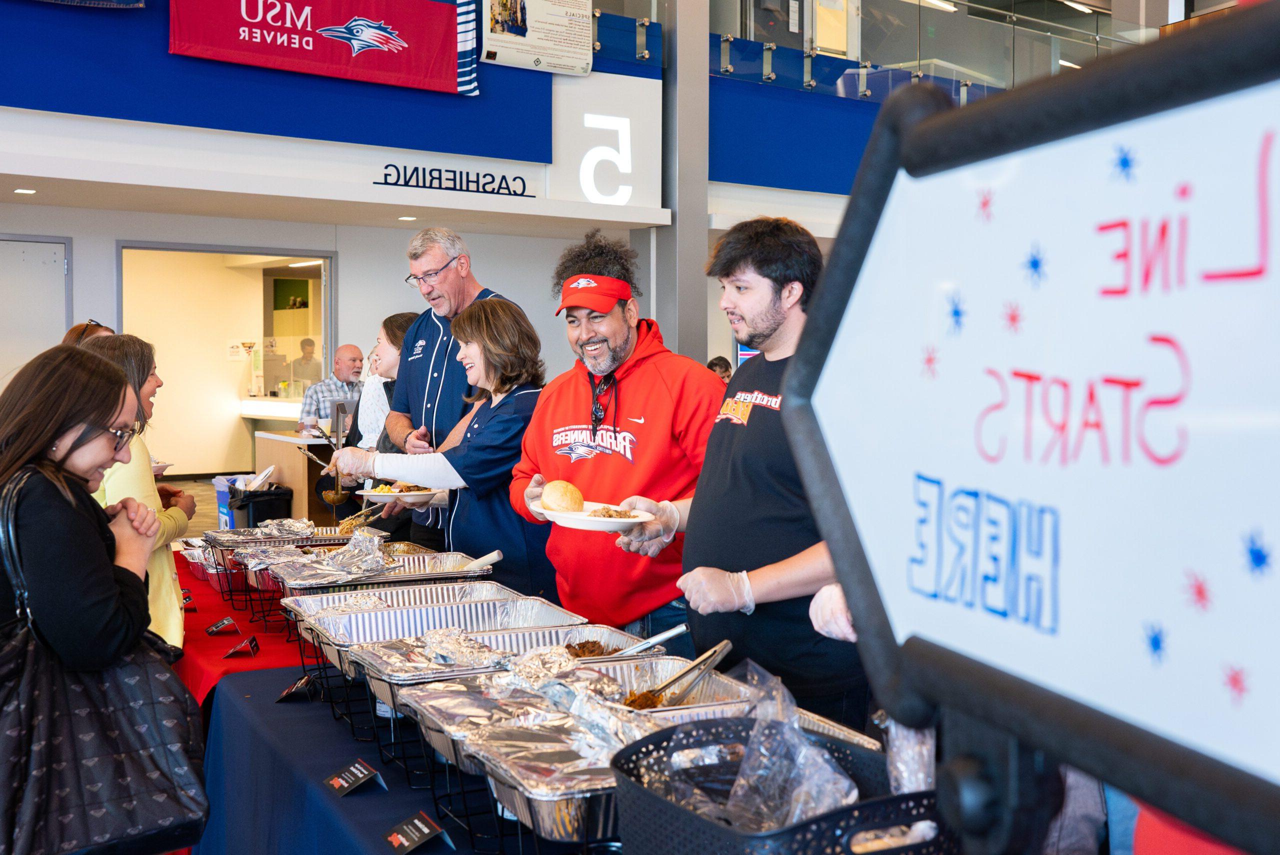 MSU Denver Senior leadership team serves food a the Faculty and Staff Appreciation BBQ