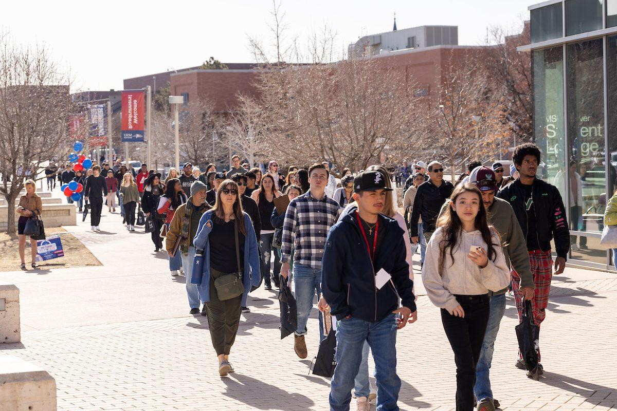 A crowd of people walk into the MSU Denver Open House