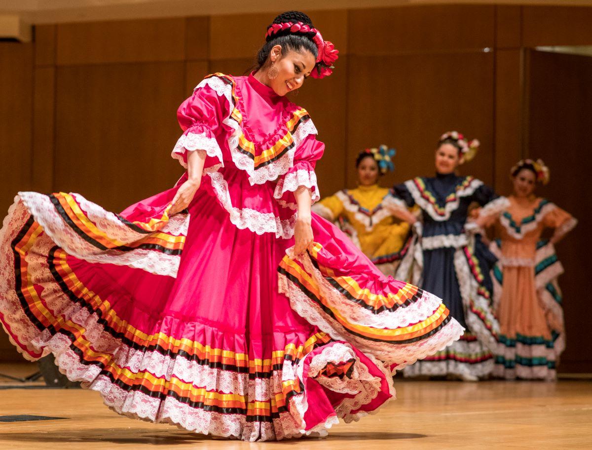 Folklorico dancer is traditional pink dress