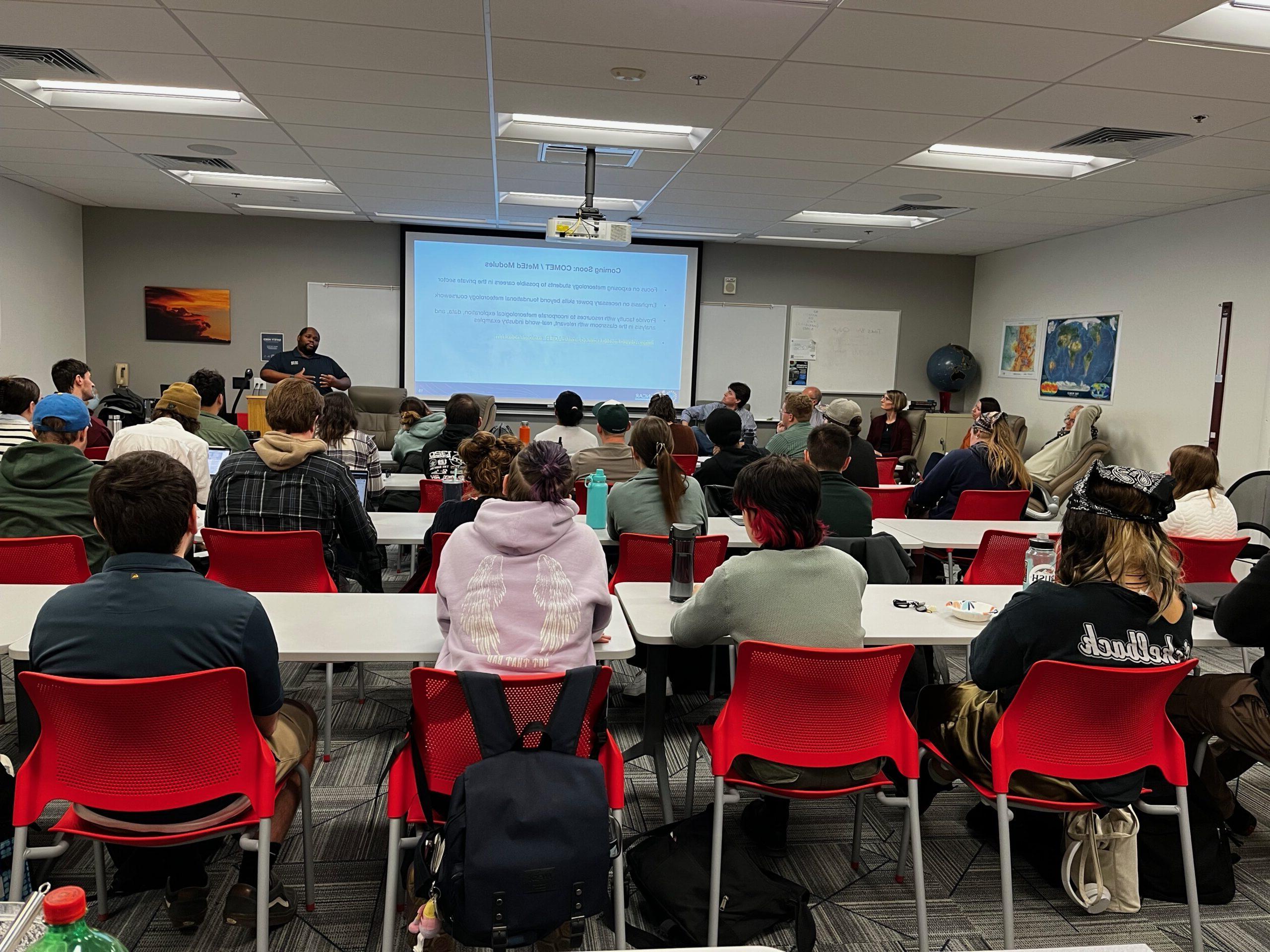 Students in the meteorology classroom watching NCAR scientists tell them about career opportunities.